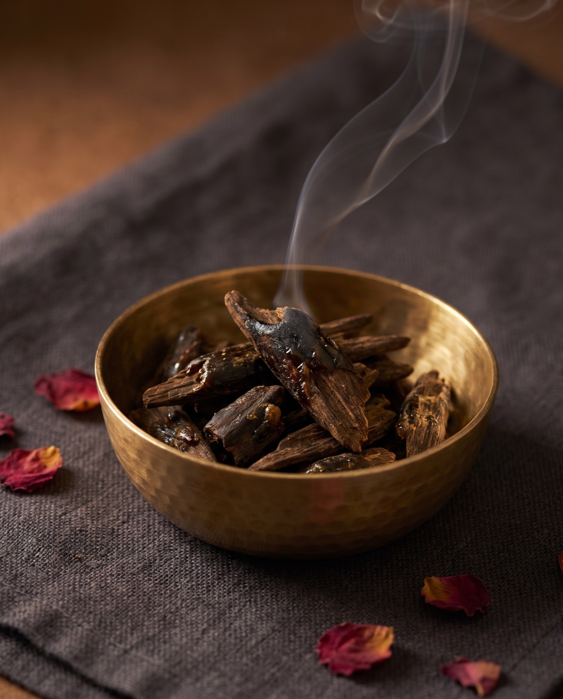 Rose Oud Bakhoor incense pieces in warm light